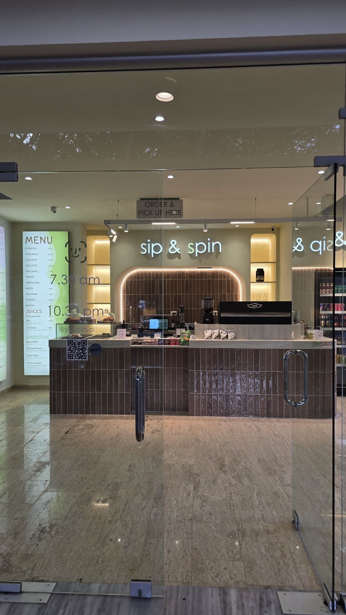 The entrance of Sip & Spin in Mali i Robit, Golem, seen from inside the shop